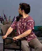 thirty something woman in chair doing a twisting pose
